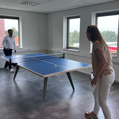 Employees enjoying a game of Ping-Pong in the break area
